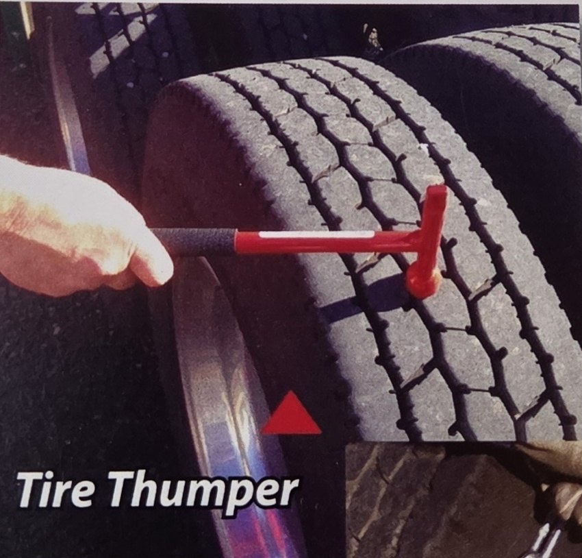 Red Super Combo Tool thumping a truck tire