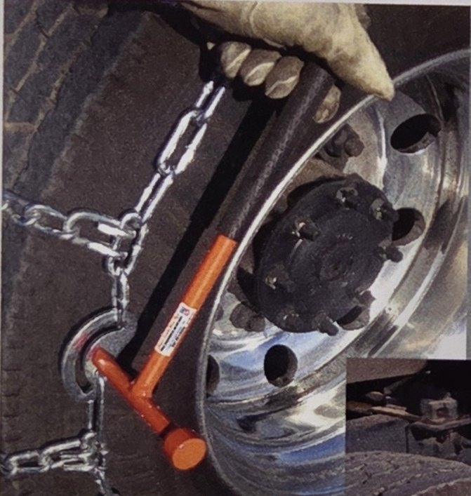 Orange Super Mini Combo Tool on a Pewag chain cam at a truck wheel