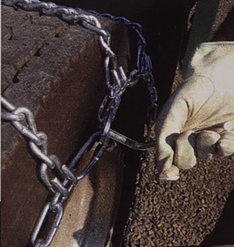 Not good: a gloved hand at the tire chain cam with no tool